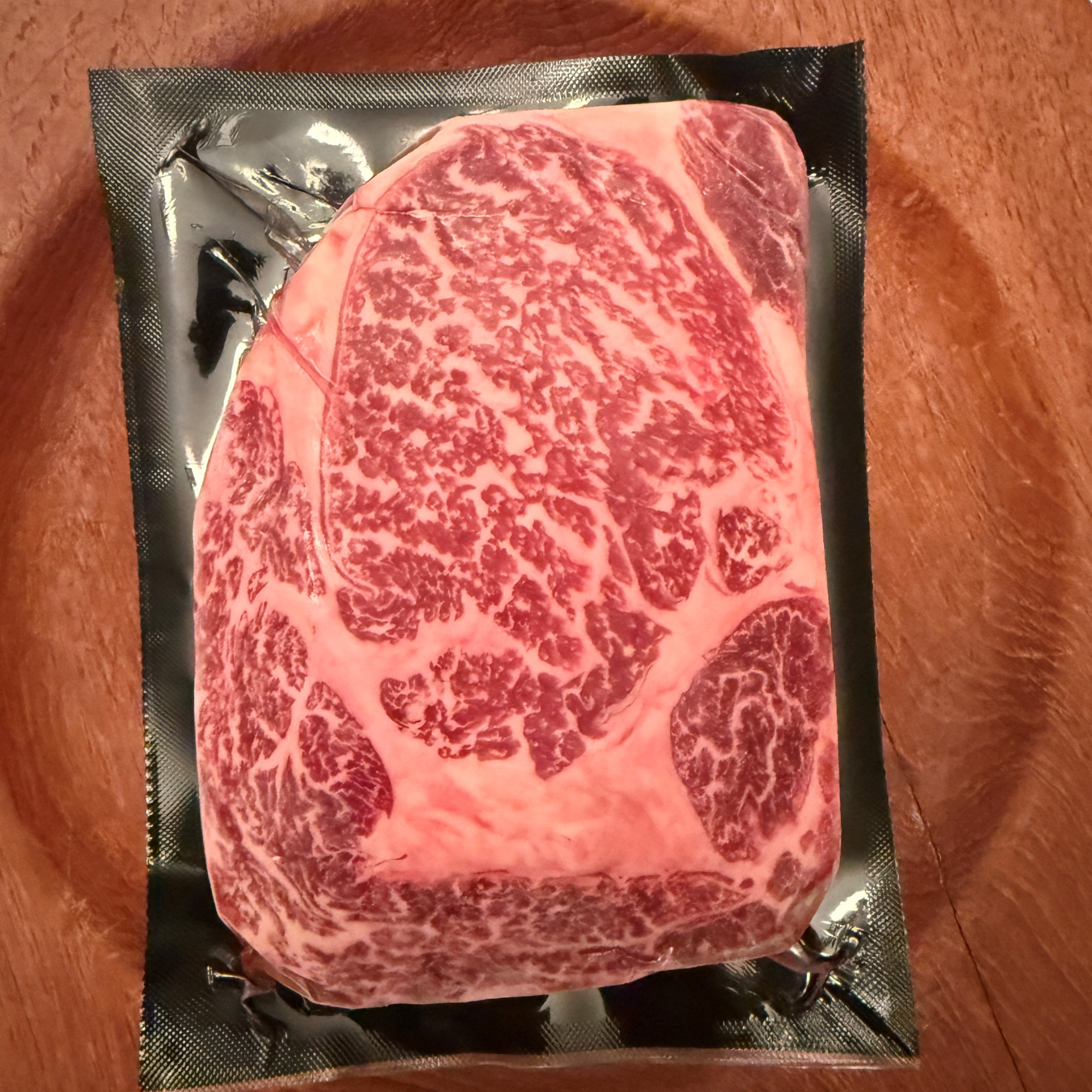 A premium, flash-frozen 100% Fullblood American Wagyu ribeye steak cleanly vacuum-sealed in heavy-duty commercial packaging by Winston Cattle Co.